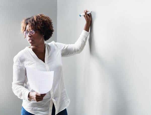 Standing at whiteboard